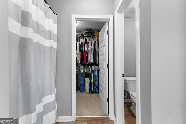 bathroom with toilet and wood finished floors