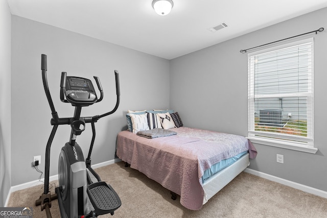 carpeted bedroom with baseboards and visible vents