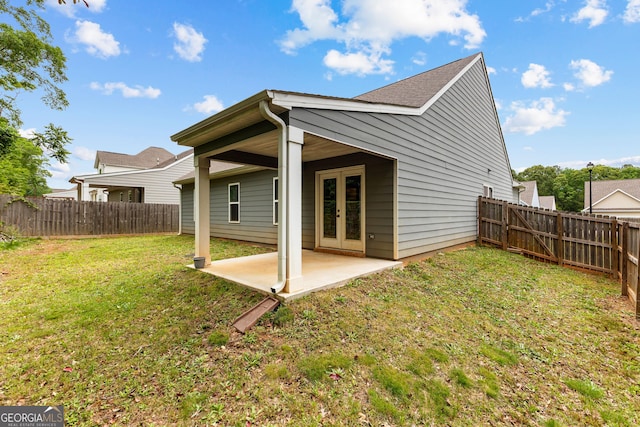 back of house featuring a yard, a patio, french doors, and a fenced backyard