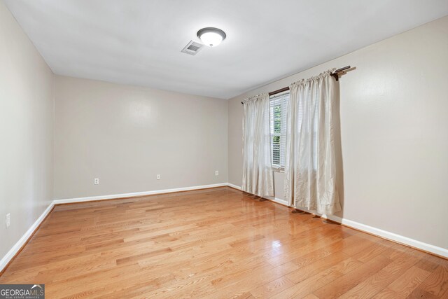 2404 Northlake Ct, Atlanta, GA 30345 - unfurnished room with visible vents, baseboards, and wood finished floors