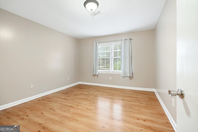 2404 Northlake Ct, Atlanta, GA 30345 - spare room featuring visible vents, baseboards, and wood finished floors