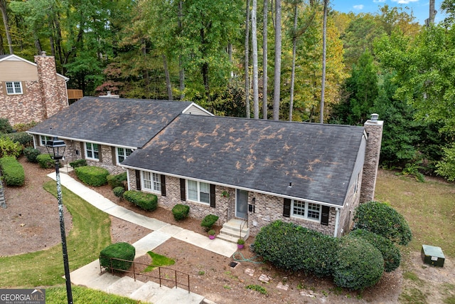 2404 Northlake Ct, Atlanta, GA 30345 - ranch-style home featuring roof with shingles, a chimney, and a fenced front yard