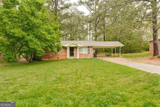 single story home featuring driveway, a front yard, an attached carport, and brick siding