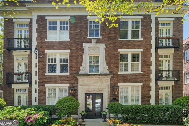 view of front of home with french doors and brick siding