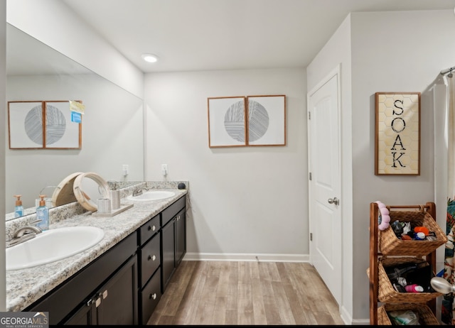 3464 Enterkin Ln, Atlanta, GA 30349 - bathroom with wood finished floors, double vanity, and baseboards