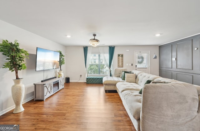 3464 Enterkin Ln, Atlanta, GA 30349 - living area featuring light wood-style flooring, baseboards, and recessed lighting