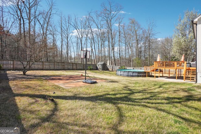161 Hunters Chase, Mcdonough, GA 30253 - view of yard with an outbuilding, a shed, a wooden deck, fence private yard, and a fenced in pool