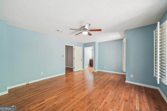 171 Riverview Trl, Roswell, GA 30075 - unfurnished bedroom featuring wood finished floors, a ceiling fan, and a textured ceiling
