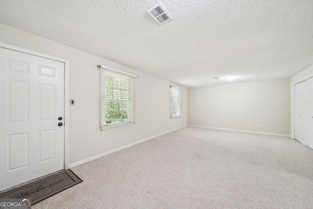 171 Riverview Trl, Roswell, GA 30075 - foyer entrance with a textured ceiling and carpet floors