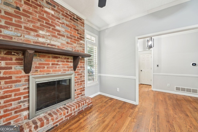 171 Riverview Trl, Roswell, GA 30075 - unfurnished living room with crown molding, a fireplace, wood finished floors, and a ceiling fan