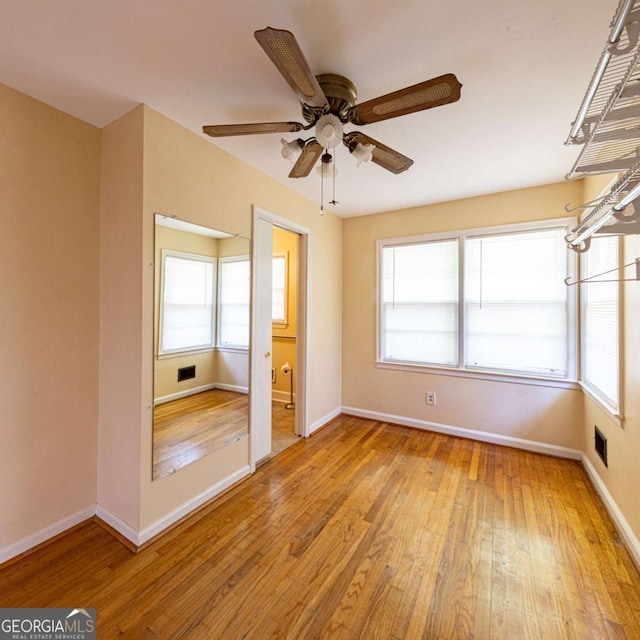unfurnished bedroom with visible vents, baseboards, light wood-type flooring, and a ceiling fan