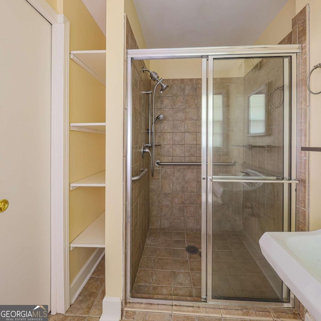 full bath featuring tile patterned floors and a stall shower