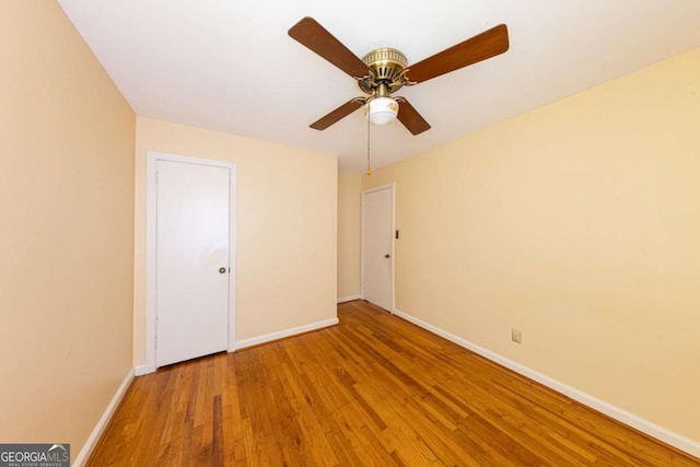 unfurnished bedroom with baseboards, ceiling fan, and wood finished floors