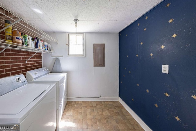 laundry room featuring baseboards, washer and dryer, laundry area, and electric panel