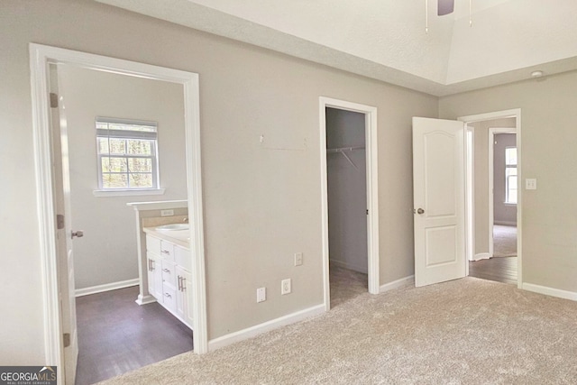 28 Willow Ridge Dr, Hampton, GA 30228 - unfurnished bedroom with a closet, baseboards, a walk in closet, and carpet flooring