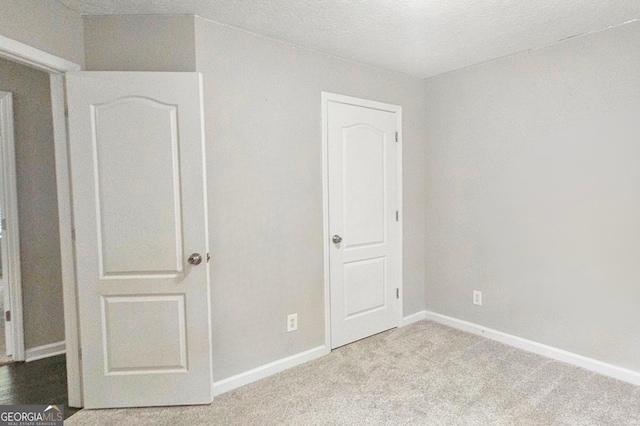 28 Willow Ridge Dr, Hampton, GA 30228 - unfurnished bedroom featuring carpet, baseboards, and a textured ceiling
