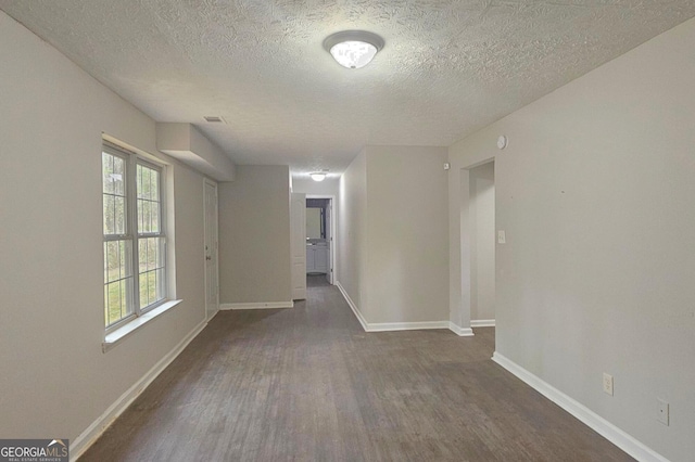 28 Willow Ridge Dr, Hampton, GA 30228 - empty room with dark wood-style flooring, a textured ceiling, and baseboards