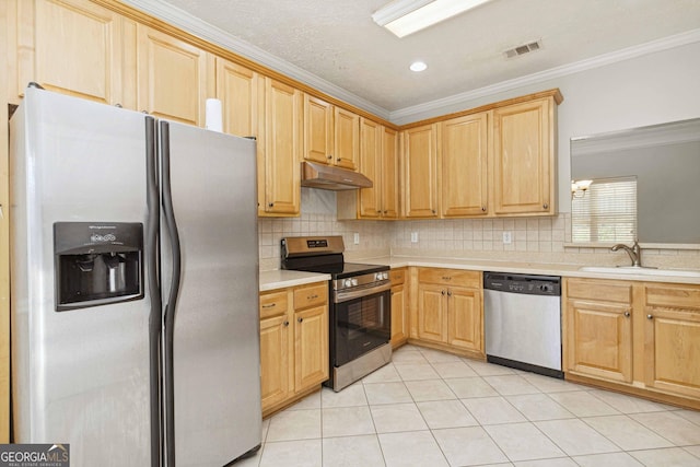 113 Highgrove Pl, Mcdonough, GA 30253 - kitchen with a sink, crown molding, under cabinet range hood, light countertops, and appliances with stainless steel finishes