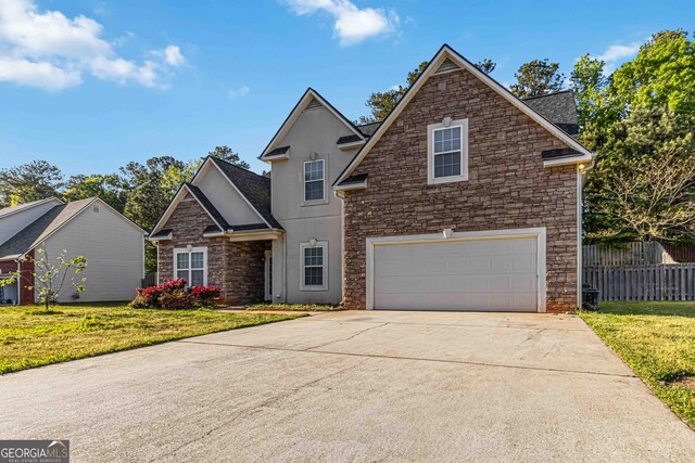 113 Highgrove Pl, Mcdonough, GA 30253 - view of front facade featuring fence, a garage, stucco siding, concrete driveway, and stone siding