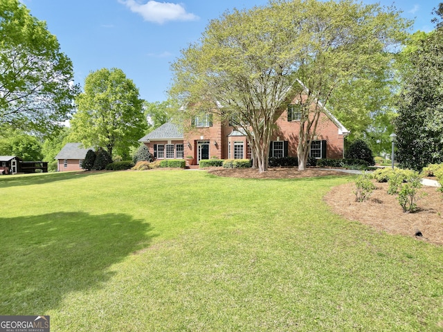 view of front of property with brick siding and a front lawn