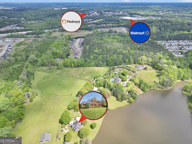 aerial view with a water view and a forest view