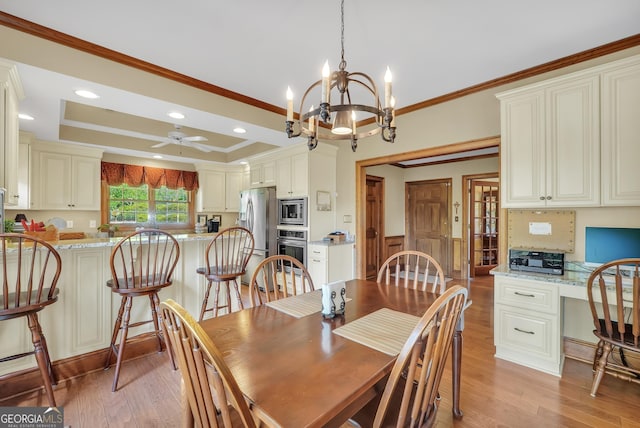 dining space with ornamental molding, light wood-style floors, and ceiling fan with notable chandelier