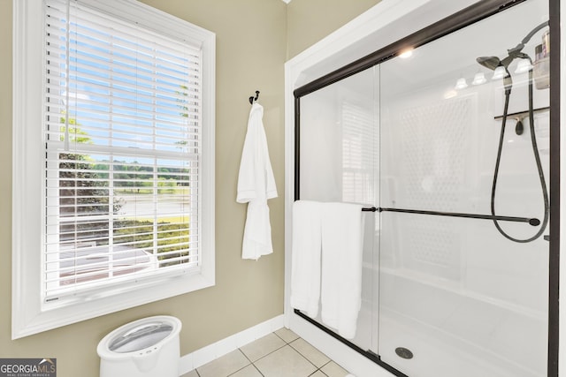 bathroom featuring a shower stall, tile patterned floors, and baseboards