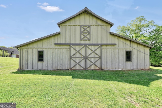 view of barn with a yard