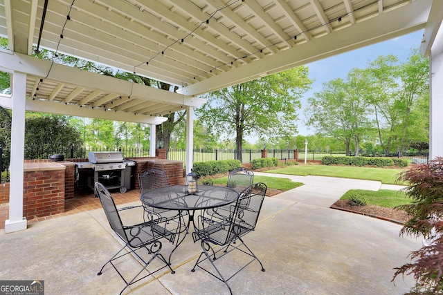 view of patio / terrace featuring grilling area, an outdoor kitchen, a fenced backyard, and outdoor dining area