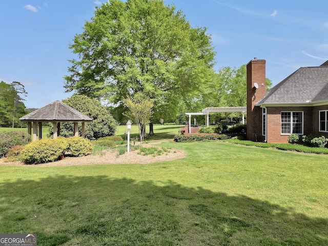 view of yard with a pergola, a gazebo, and an attached carport
