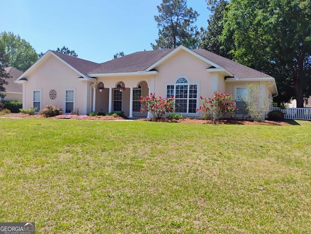 145 Spring Lake Cir, Brunswick, GA 31525 - single story home featuring stucco siding, fence, and a front yard