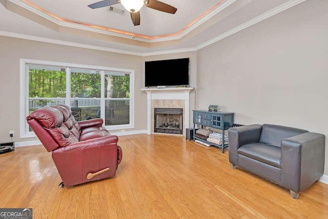 145 Spring Lake Cir, Brunswick, GA 31525 - living room with ornamental molding, a raised ceiling, visible vents, ceiling fan, and wood finished floors