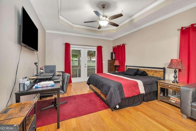 145 Spring Lake Cir, Brunswick, GA 31525 - bedroom with crown molding, a tray ceiling, wood finished floors, access to exterior, and french doors
