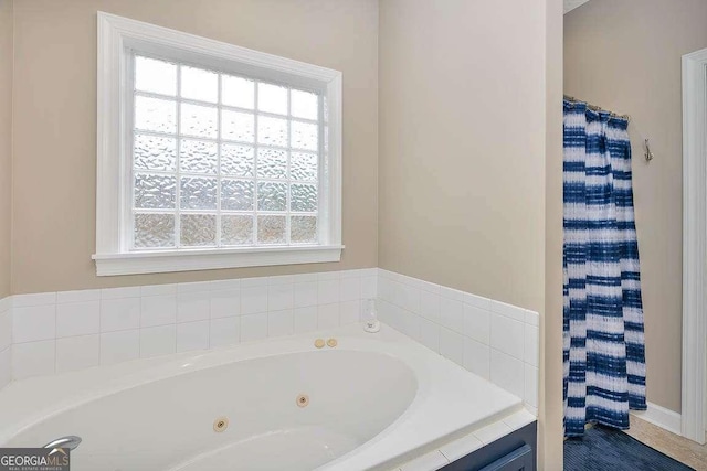 145 Spring Lake Cir, Brunswick, GA 31525 - bathroom featuring a whirlpool tub, a shower with shower curtain, and a healthy amount of sunlight