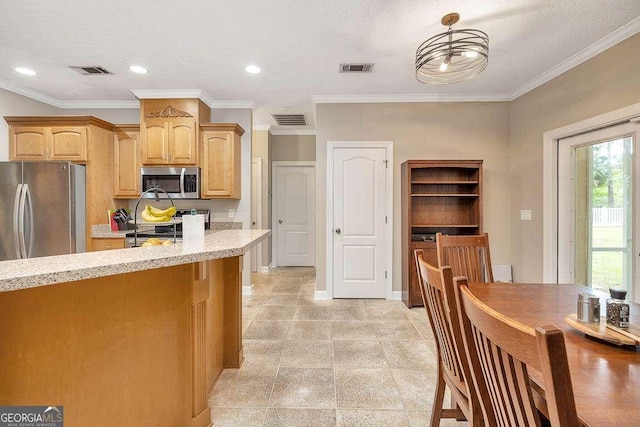 145 Spring Lake Cir, Brunswick, GA 31525 - kitchen with light stone countertops, appliances with stainless steel finishes, and visible vents