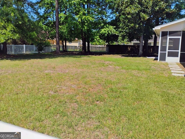 145 Spring Lake Cir, Brunswick, GA 31525 - view of yard with a sunroom and a fenced backyard