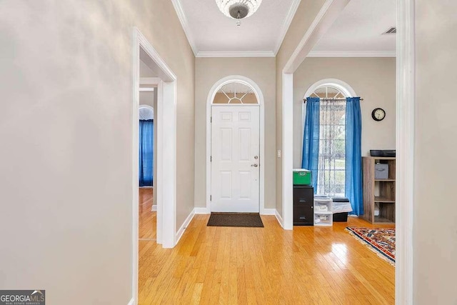 145 Spring Lake Cir, Brunswick, GA 31525 - entrance foyer with light wood-type flooring, visible vents, crown molding, and baseboards