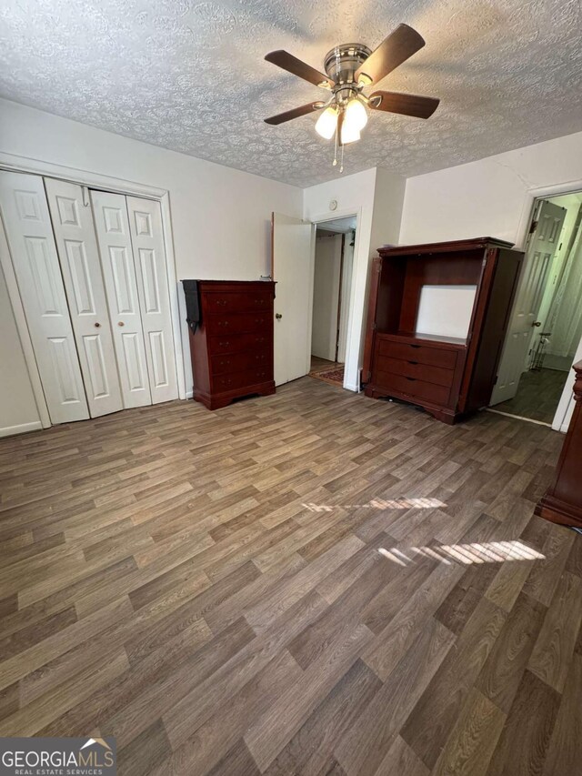 6695 Cedar Hurst Trl, Atlanta, GA 30349 - unfurnished bedroom featuring a closet, ceiling fan, a textured ceiling, and wood finished floors