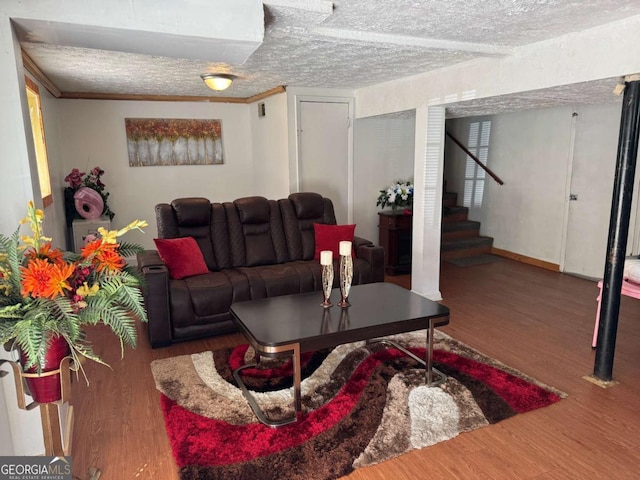 6695 Cedar Hurst Trl, Atlanta, GA 30349 - living area with a textured ceiling, wood finished floors, baseboards, and stairs