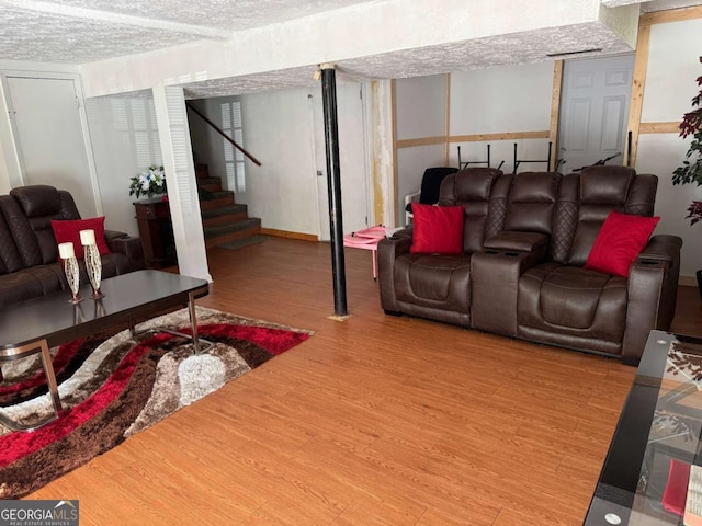 6695 Cedar Hurst Trl, Atlanta, GA 30349 - living room with baseboards, wood finished floors, and stairs