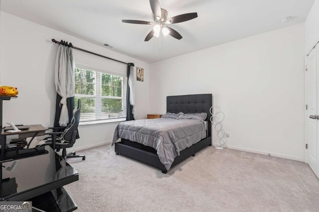 bedroom with visible vents, baseboards, a ceiling fan, and carpet flooring