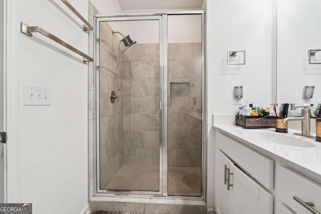 bathroom with a stall shower and vanity
