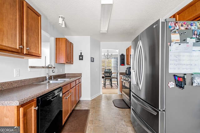 33 Blue Springs Way, Dallas, GA 30157 - kitchen featuring stainless steel appliances, a sink, brown cabinets, dark countertops, and a textured ceiling