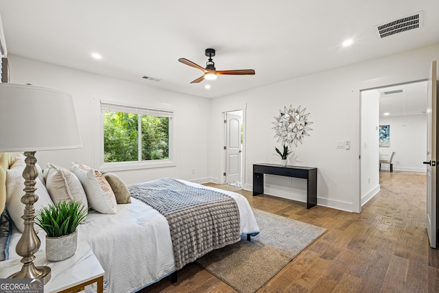 bedroom with wood finished floors, visible vents, and recessed lighting