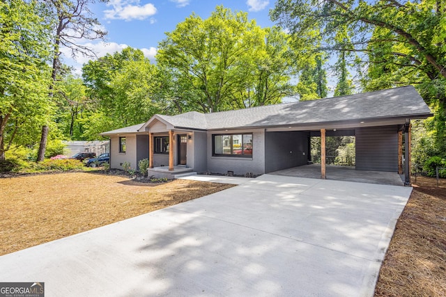 single story home featuring driveway and an attached carport