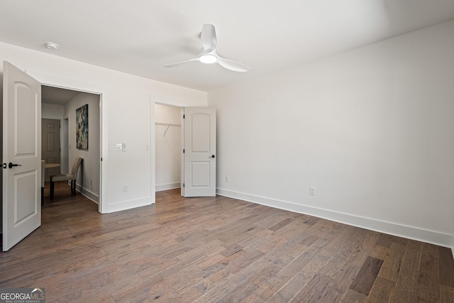 unfurnished bedroom with wood finished floors, baseboards, and ceiling fan