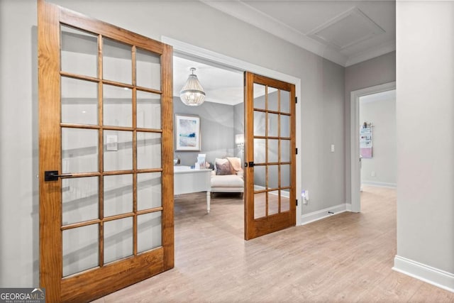 interior space with wood finished floors, french doors, and baseboards