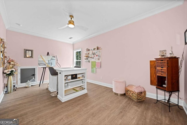 office featuring wood finished floors, ceiling fan, ornamental molding, and baseboards