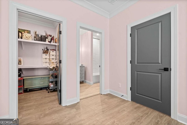 bedroom featuring wood finished floors, ornamental molding, and baseboards