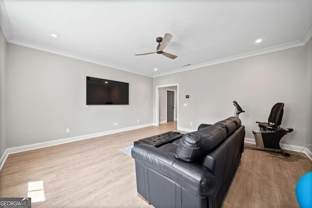 living room featuring ornamental molding, a ceiling fan, wood finished floors, and baseboards